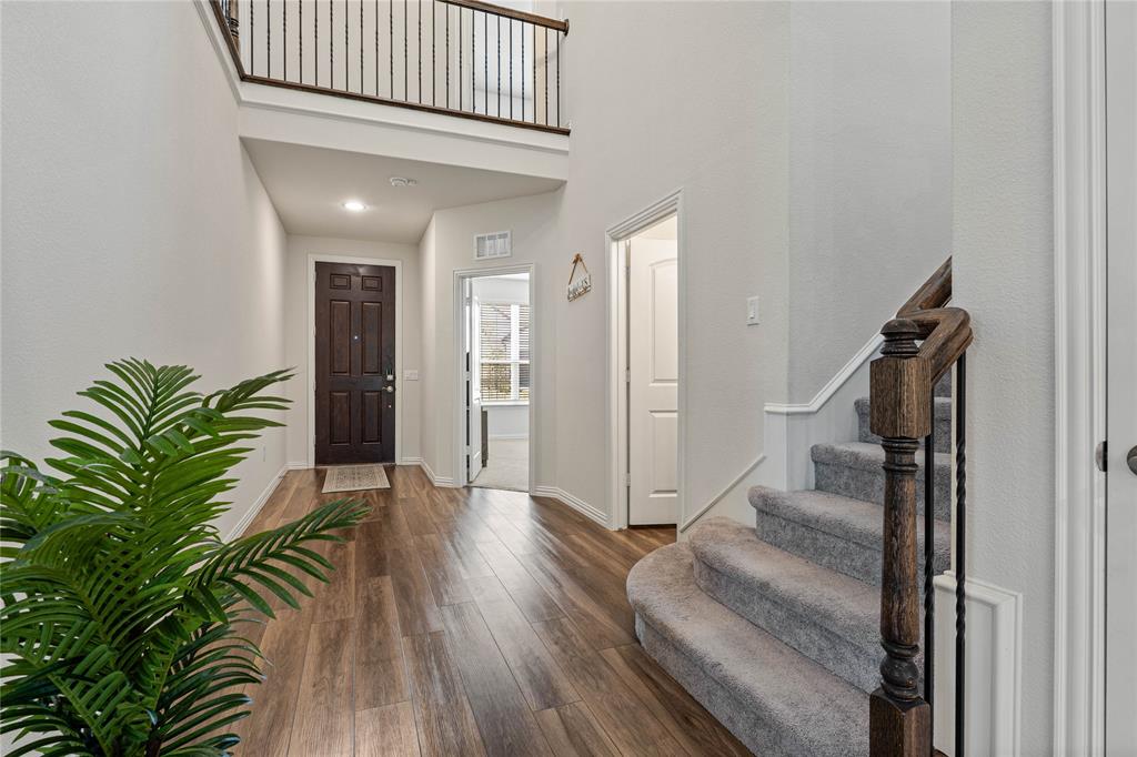 9517 Sunset Lane Oak Point, TX 75068 - Photo 3 of 40 9517 Sunset Lane, Oak Point, TX 75068 - foyer - Foyer entrance featuring dark wood finished floors, a high ceiling, and recessed lighting