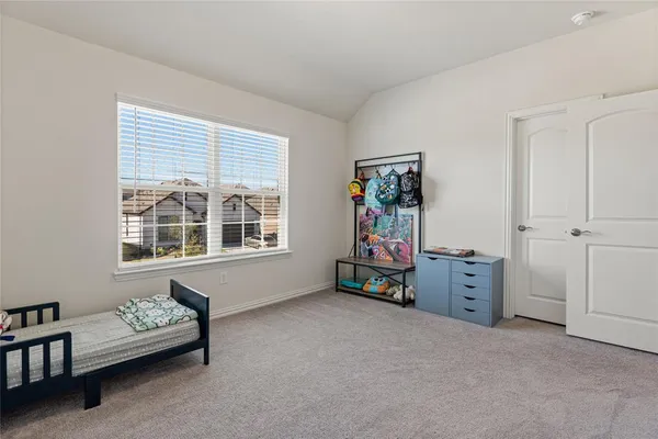 a bedroom with a bed and a dresser