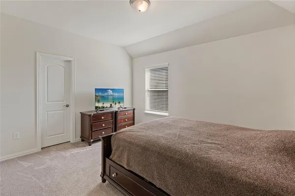 a bed sitting in a room next to a window