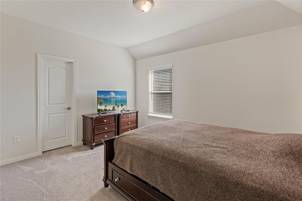 9517 Sunset Lane Oak Point, TX 75068 - Photo 35 of 40 a bedroom with a bed and a dresser