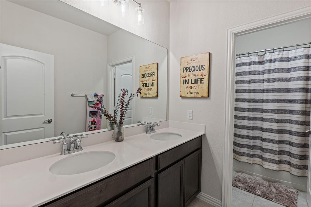 9517 Sunset Lane Oak Point, TX 75068 - Photo 36 of 40 9517 Sunset Lane, Oak Point, TX 75068 - full bathroom - Bathroom with double vanity and light tile patterned floors