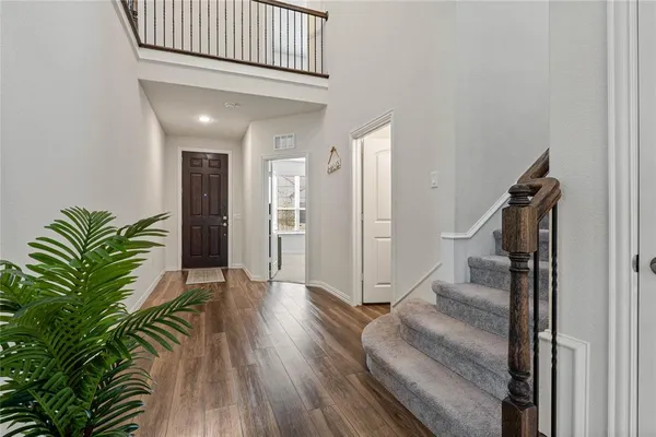 a view of entryway with wooden floor and stairs
