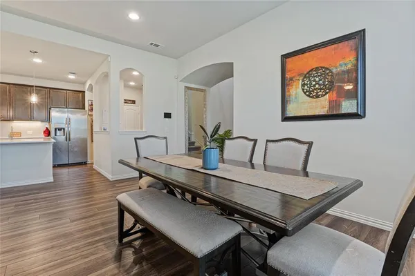 a view of a dining room with furniture and wooden floor