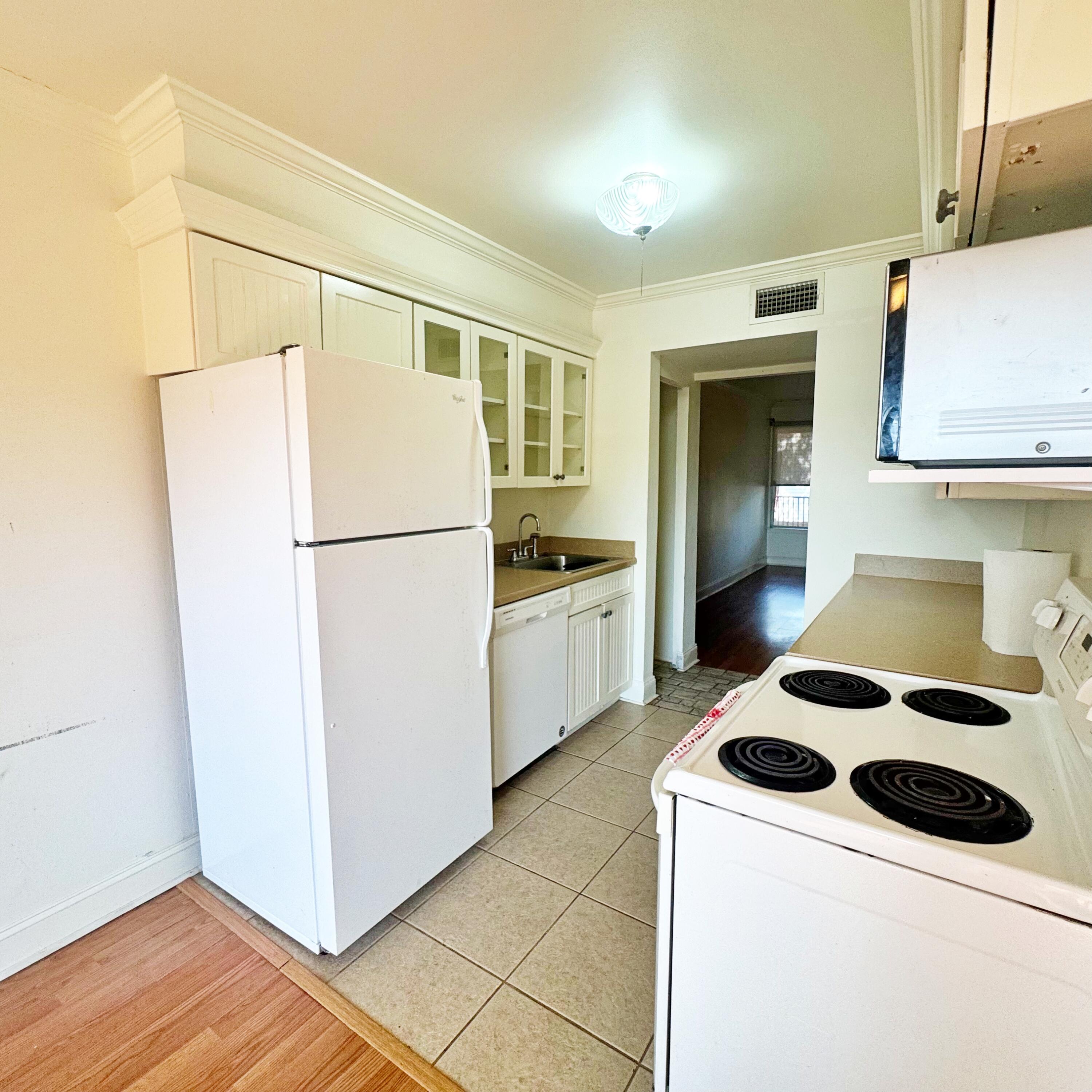 210 Pelham Road, Unit 215B Fort Walton Beach, FL 32547 - Photo 5 of 23 a kitchen with a refrigerator and a stove