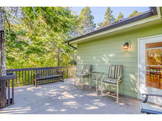 a balcony with table and chairs