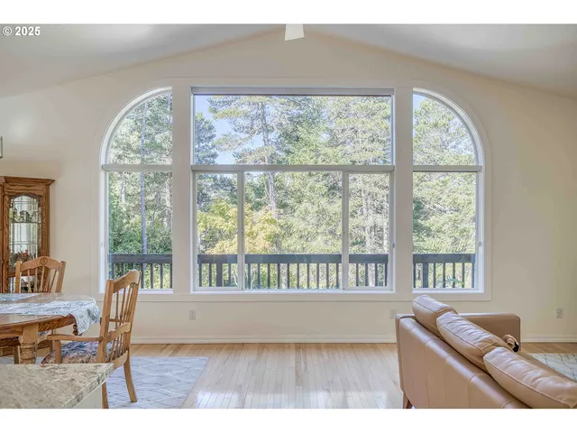 a living room with a large window and table