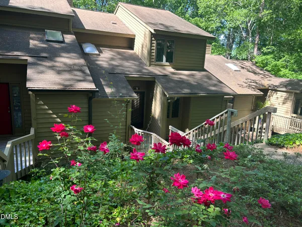a view of a house with a lot of flower plants