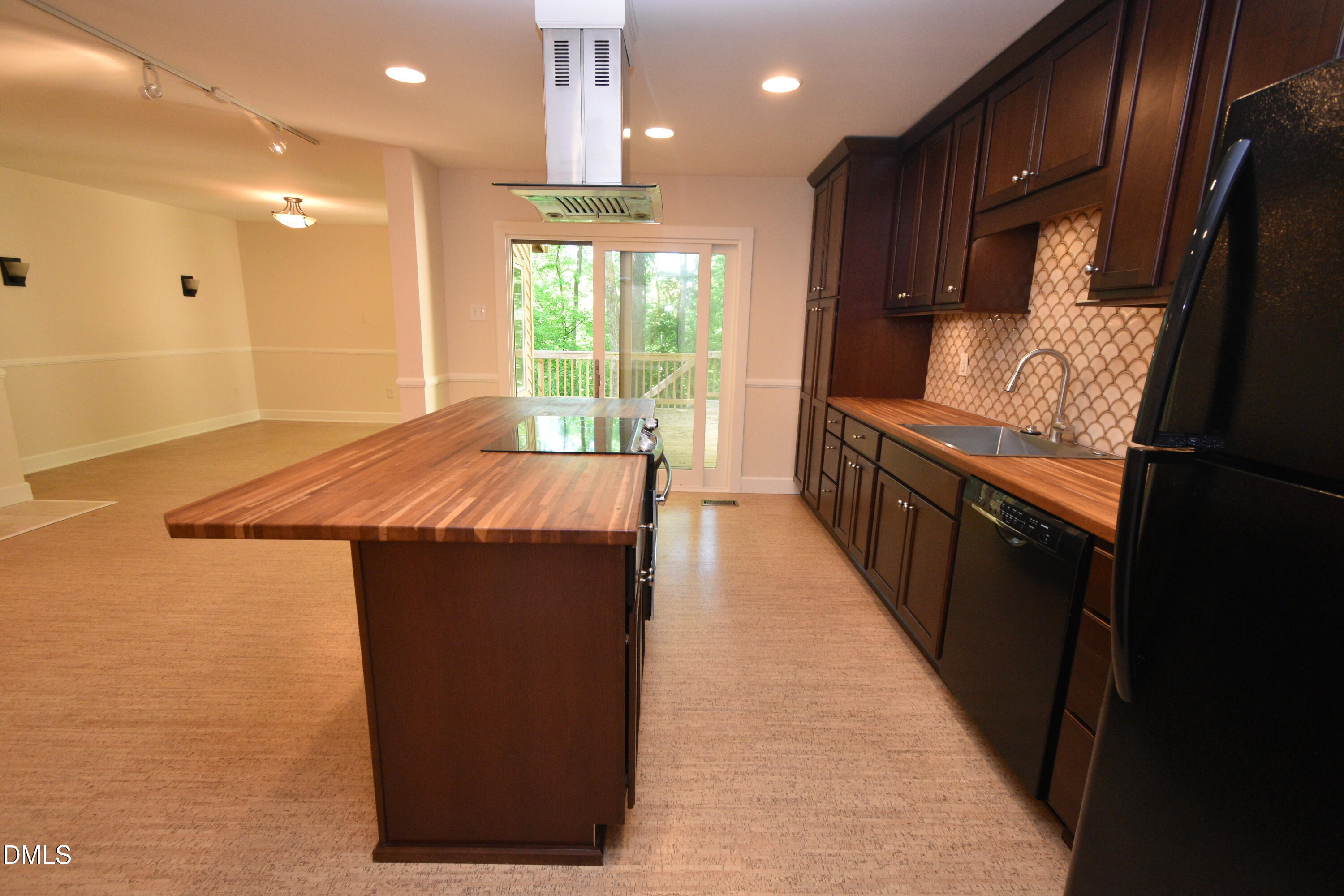 72 Stoneridge Road Durham, NC 27705 - Photo 11 of 28 a kitchen with kitchen island a sink appliances and cabinets