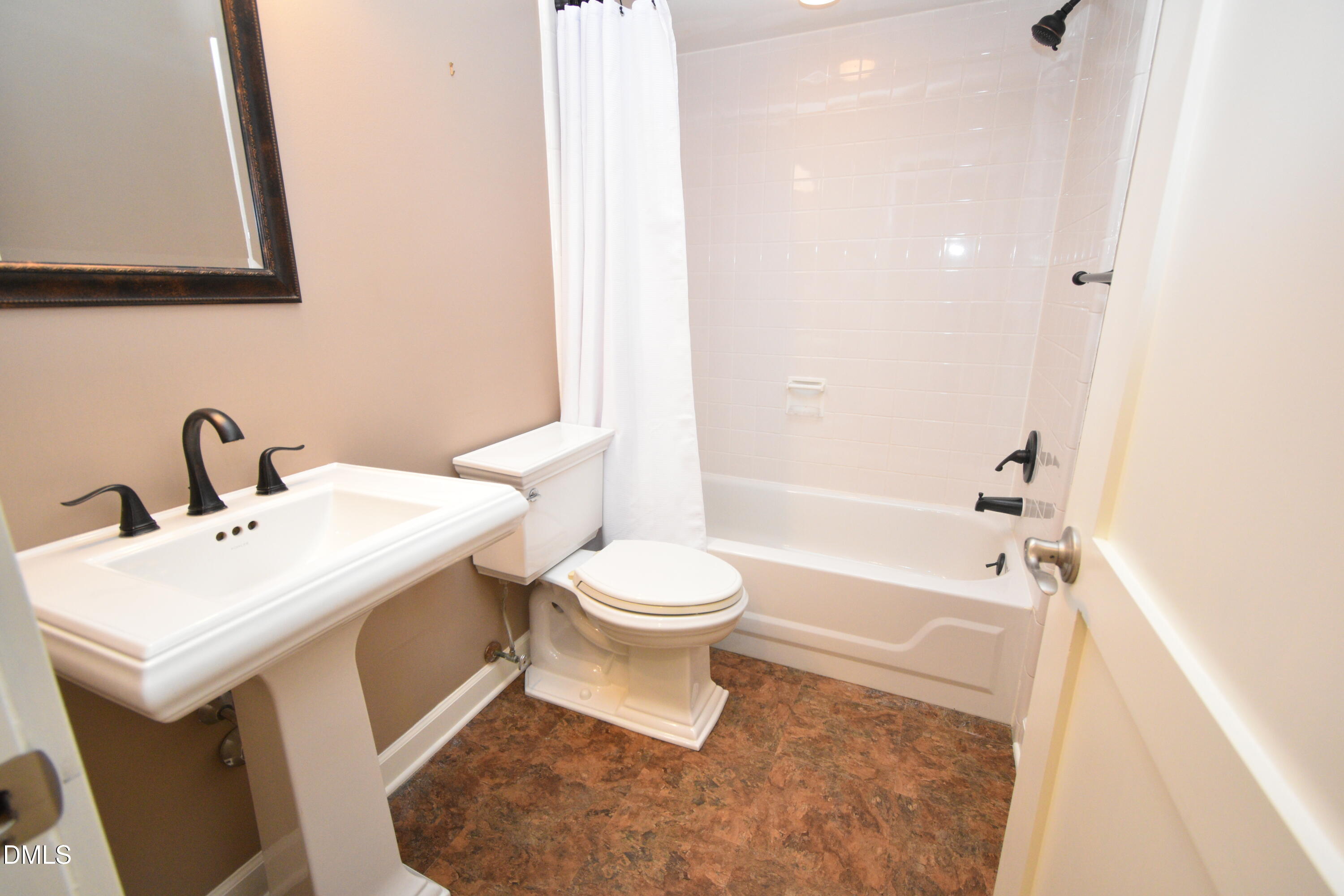 72 Stoneridge Road Durham, NC 27705 - Photo 15 of 28 a bathroom with a sink a toilet and shower