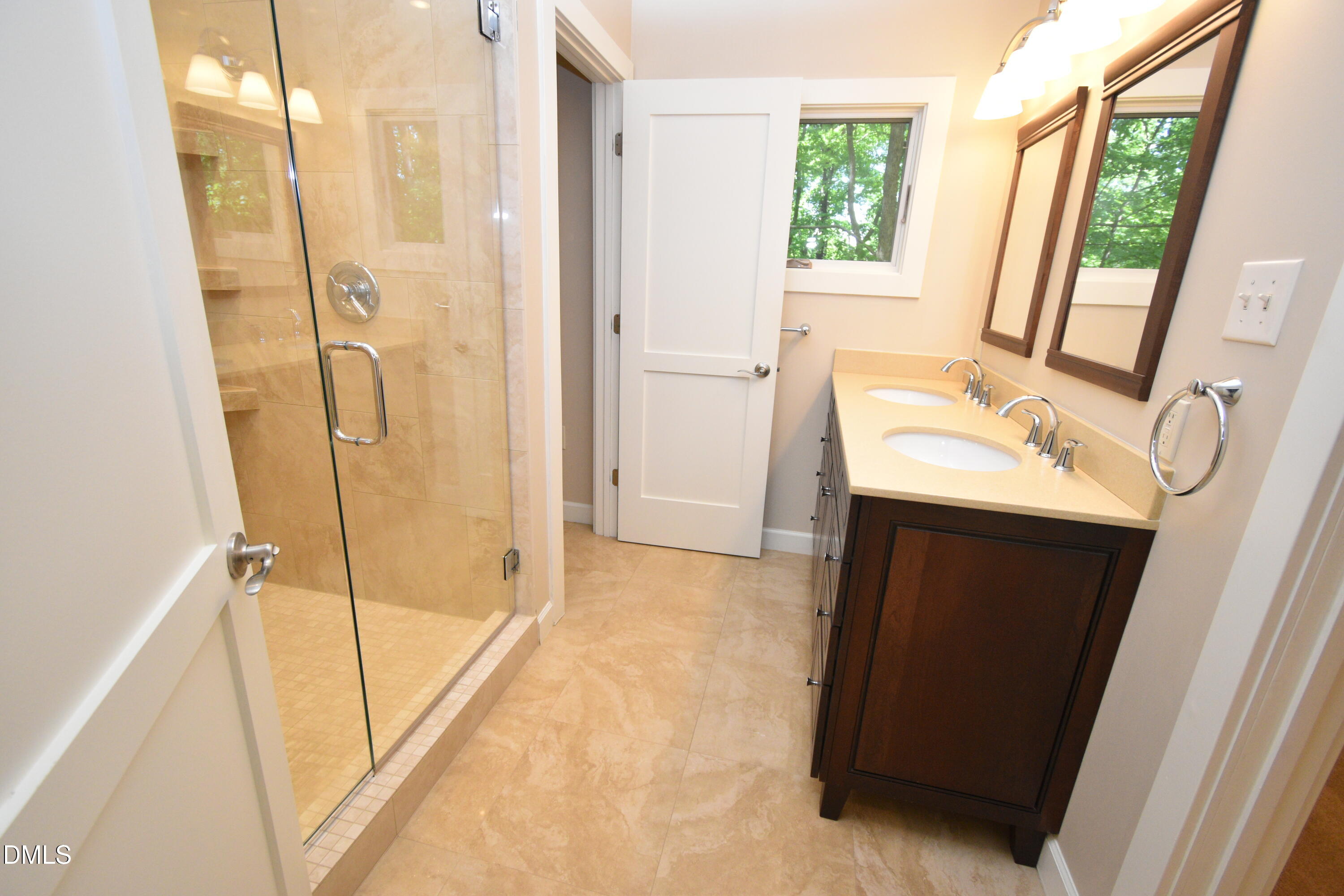 72 Stoneridge Road Durham, NC 27705 - Photo 23 of 28 a bathroom with a sink a mirror and a shower