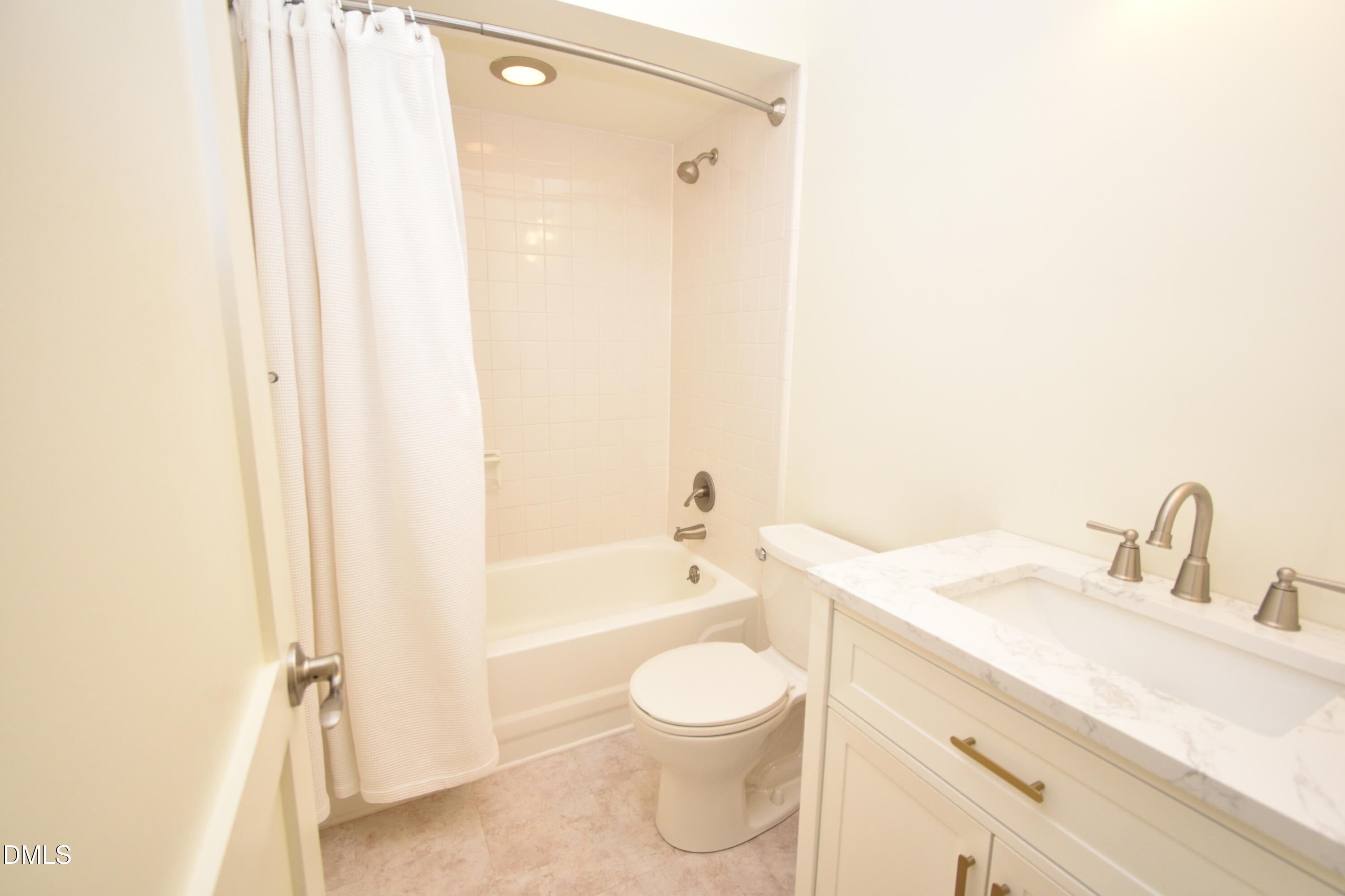 72 Stoneridge Road Durham, NC 27705 - Photo 24 of 28 a bathroom with a granite countertop sink toilet a mirror and shower