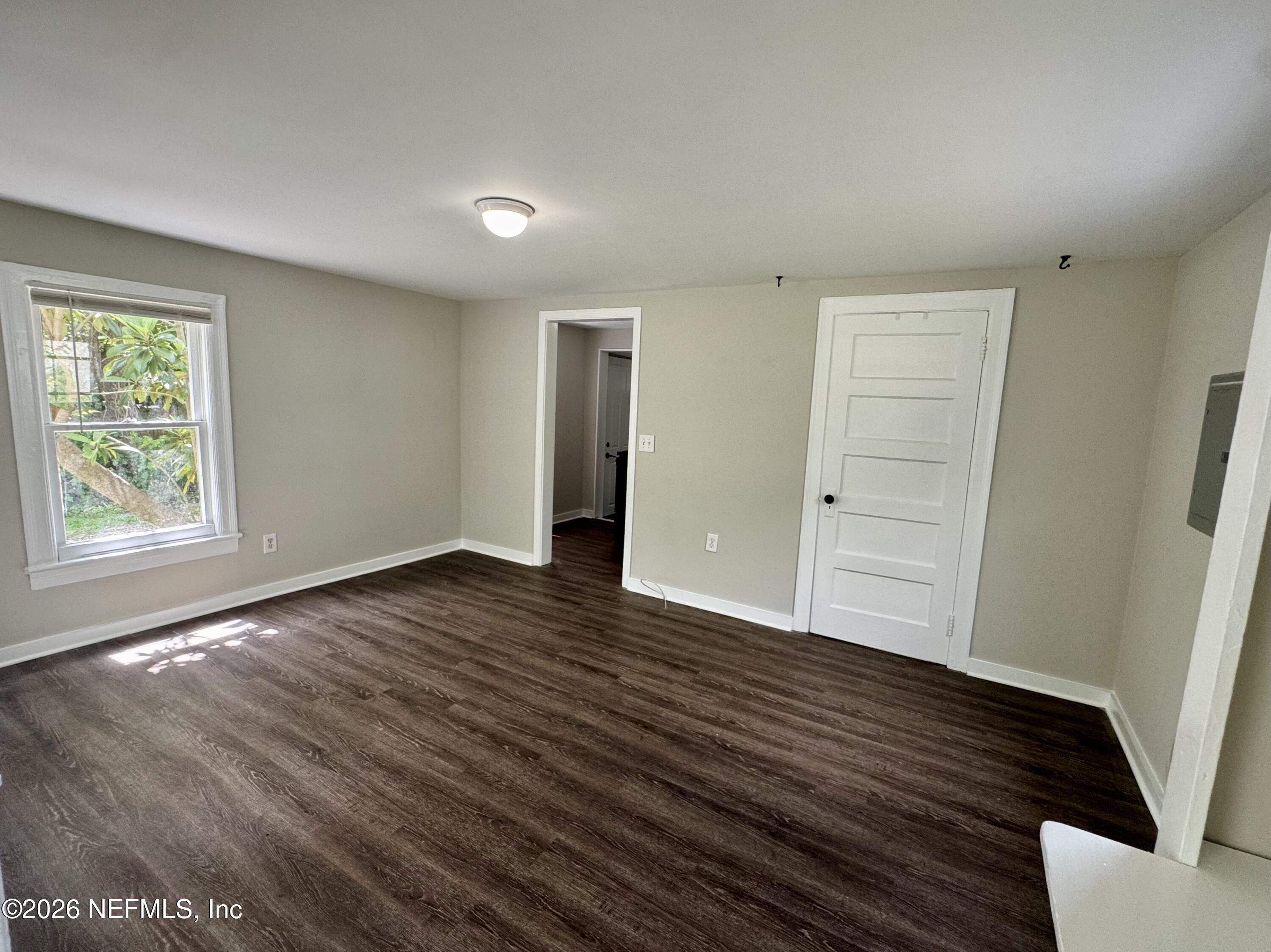 3673 Randall Street Jacksonville, FL 32205 - Photo 4 of 9 wooden floor in an empty room with a window