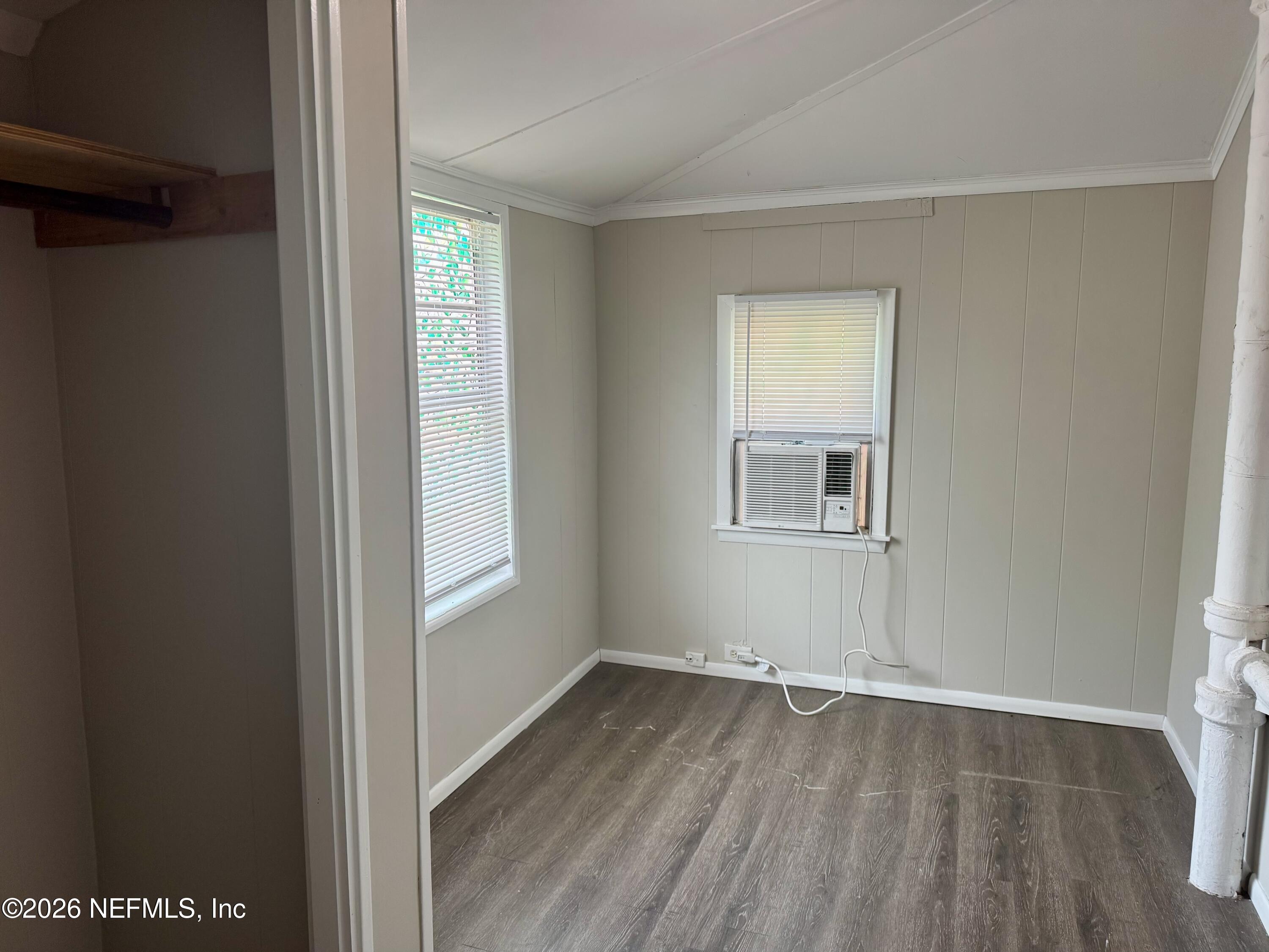 3673 Randall Street Jacksonville, FL 32205 - Photo 9 of 9 a view of an empty room with wooden floor and a window