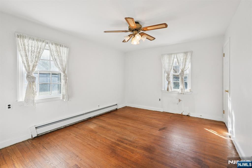 14 Valhalla Way Wayne, NJ 07470 - Photo 13 of 32 a view of empty room with wooden floor and fan
