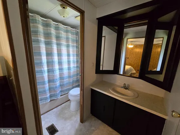 a bathroom with a double vanity sink toilet and shower