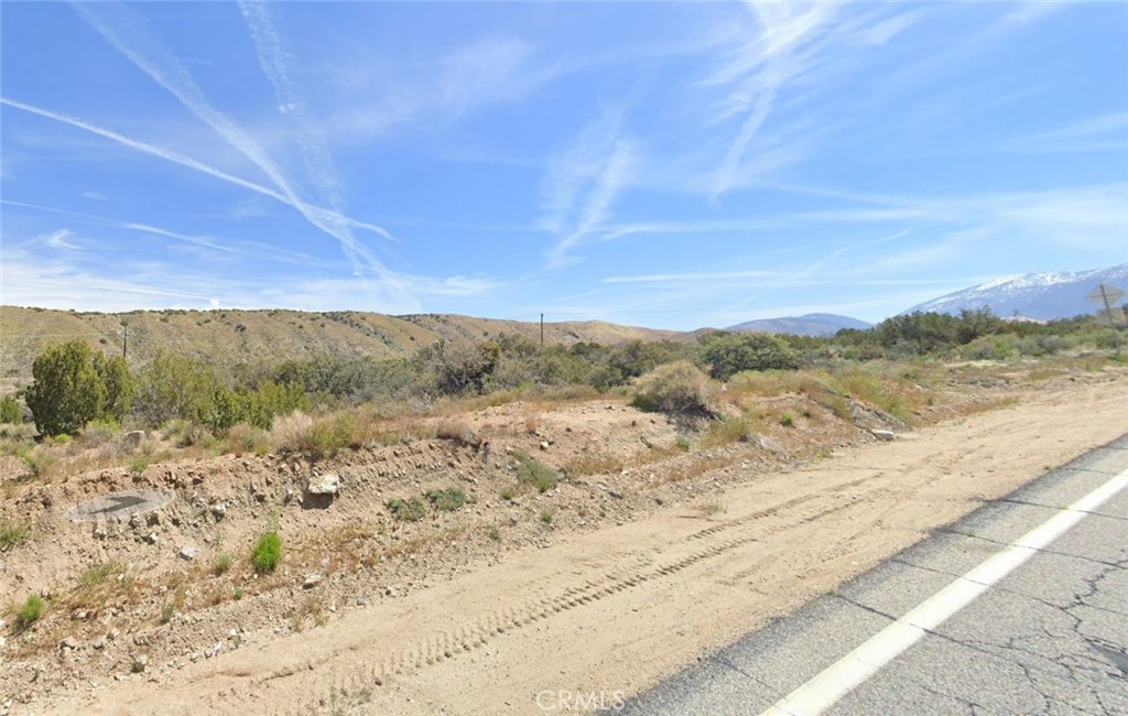 29500 Longview Road Pearblossom, CA 93553 - Photo 4 of 5 a view of a dry yard with wooden fence