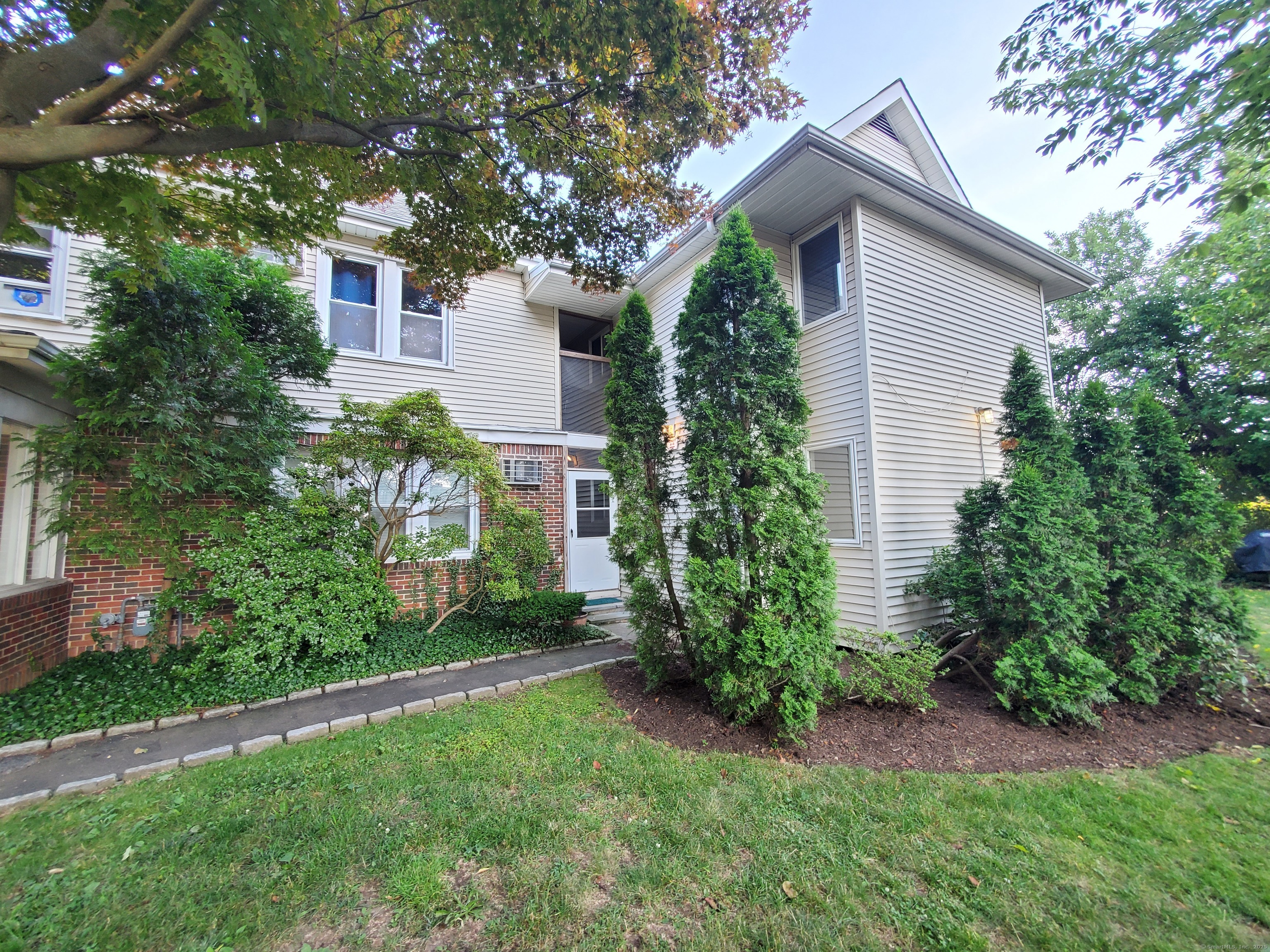 1 Rock Spring Road Stamford, CT 06906 - Photo 2 of 4 a view of a house with a yard and plants