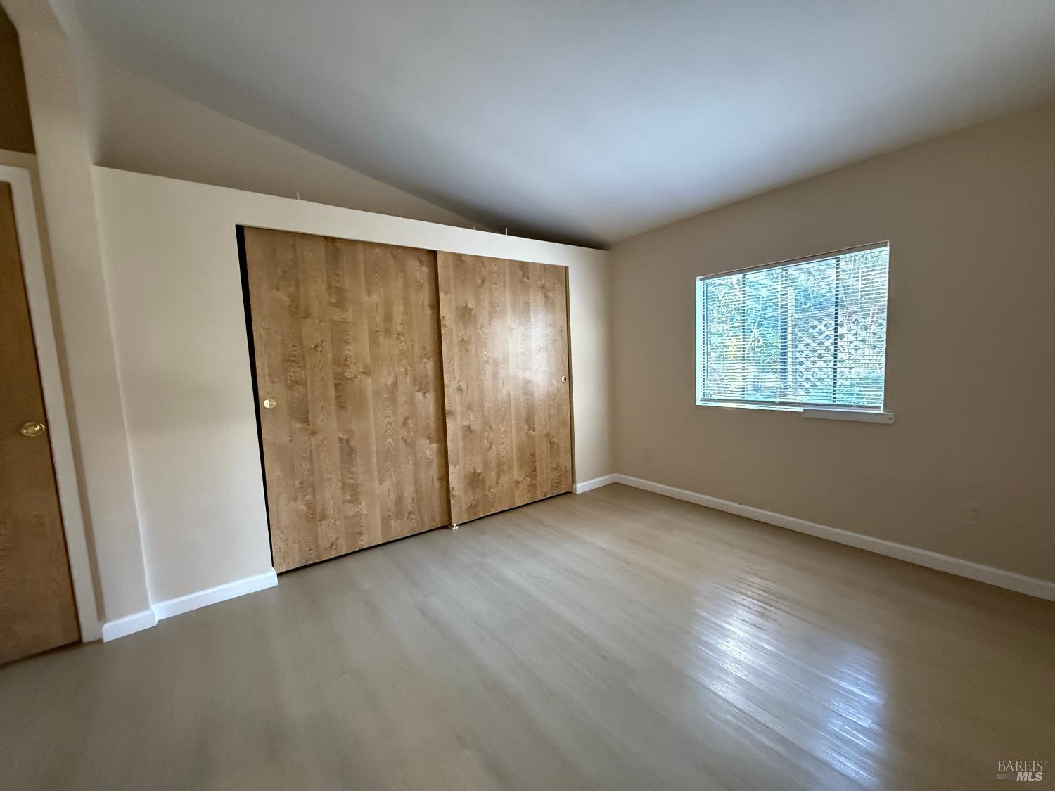 190 Apple Lane Santa Rosa, CA 95407 - Photo 17 of 23 an empty room with wooden floor closet and windows
