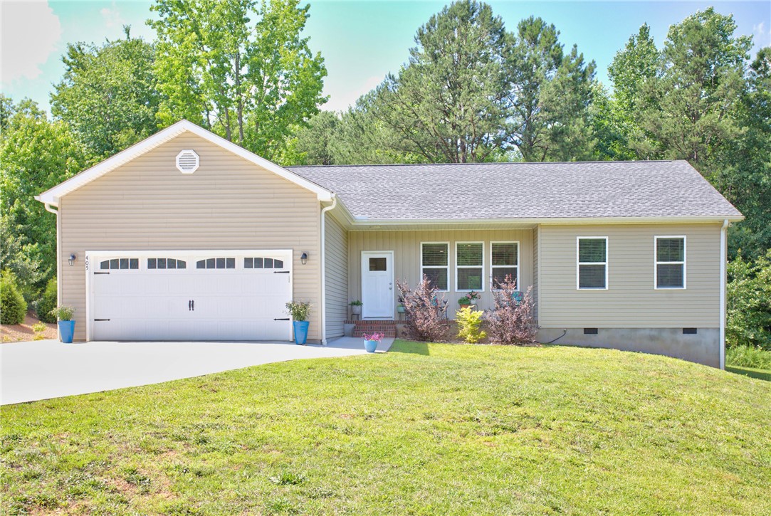 405 Pawnee Drive Walhalla, SC 29691 - Photo 1 of 36 A neatly maintained lawn surrounds this charming home with an attached garage and a welcoming front porch.