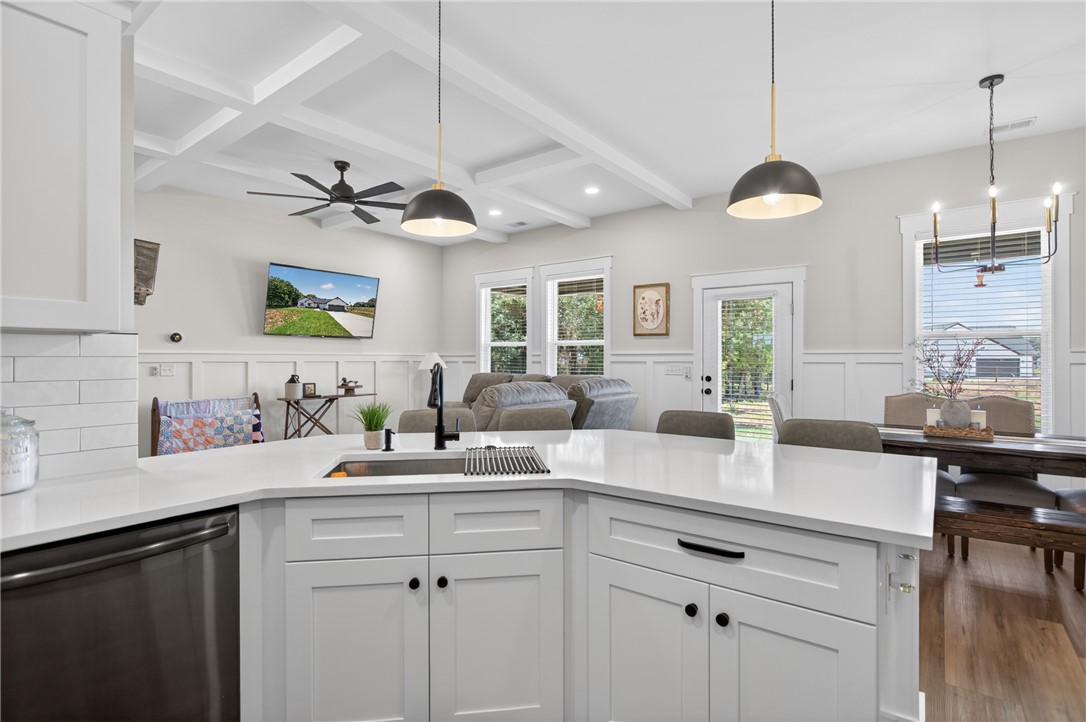 106 Bolt Road Townville, SC 29689 - Photo 8 of 33 A pristine kitchen island with white cabinetry offers abundant counter space and seating for guests.