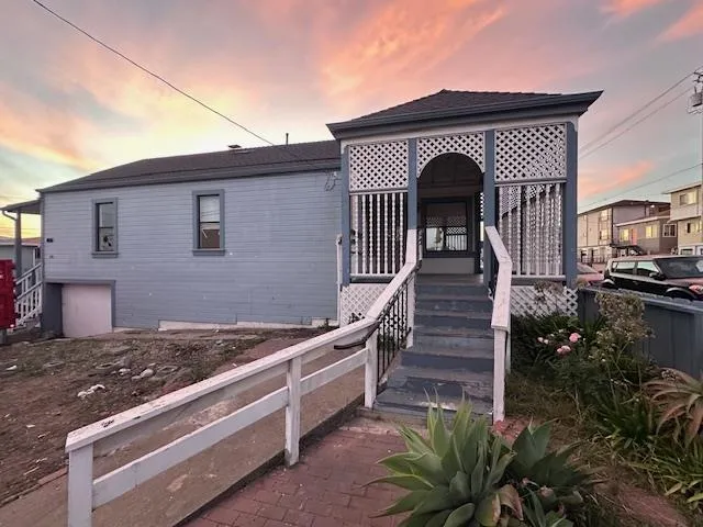 a front view of a house with stairs