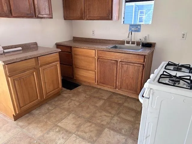 a kitchen with sink cabinets and stove