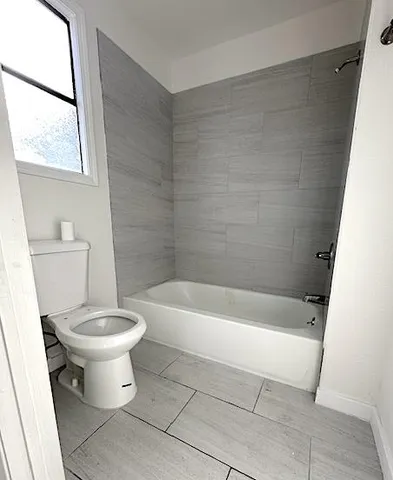 a bathroom with a bathtub and toilet