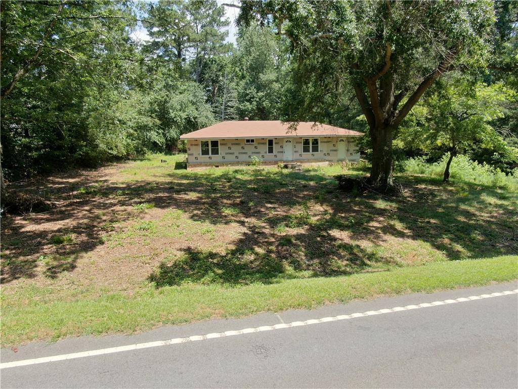 a backyard of a house with yard and outdoor seating