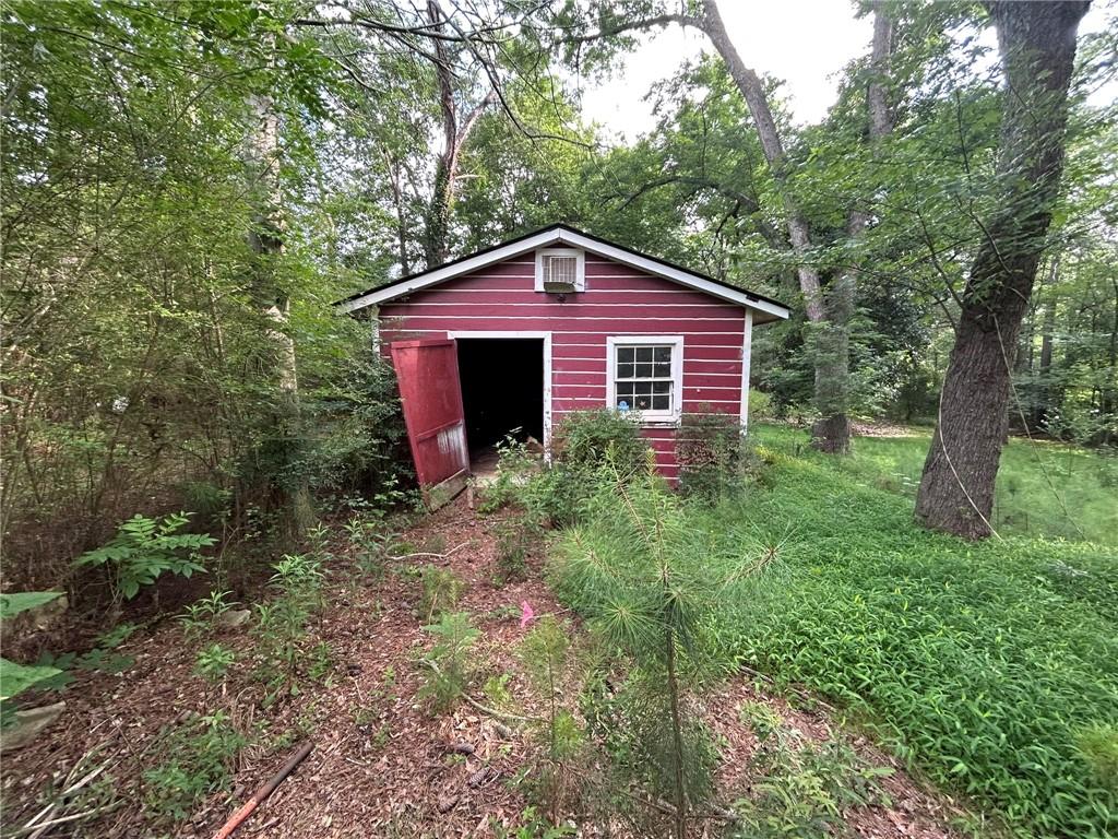 8916 Highway 166 Winston, GA 30187 - Photo 19 of 52 a front view of a house with garden