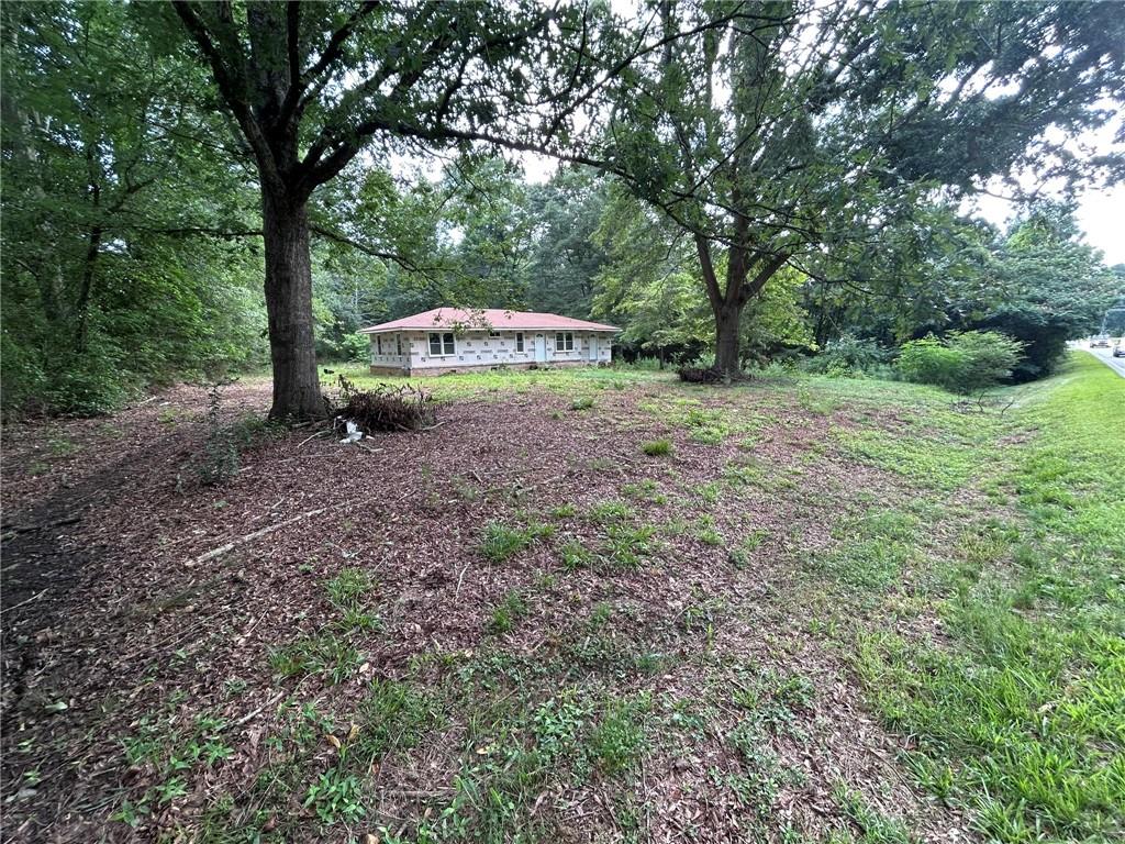 8916 Highway 166 Winston, GA 30187 - Photo 2 of 52 a dirt road with trees in the background