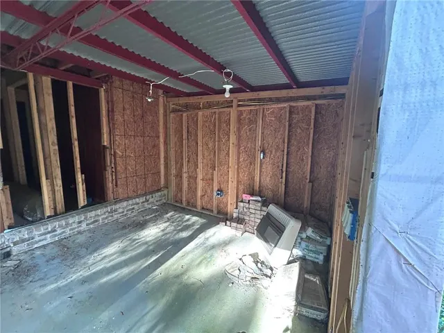 a view of a hallway with wooden walls