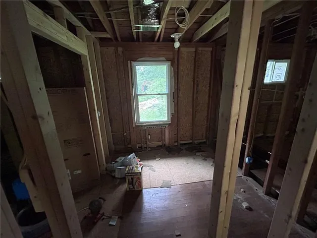 a room with wooden floor and furniture