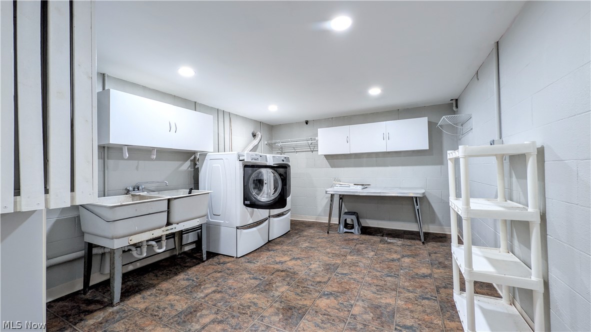 6409 Old Woods Road Ashtabula, OH 44004 - Photo 25 of 43 Dedicated laundry area featuring dual utility sinks, overhead cabinetry, and recessed lighting m on lower level