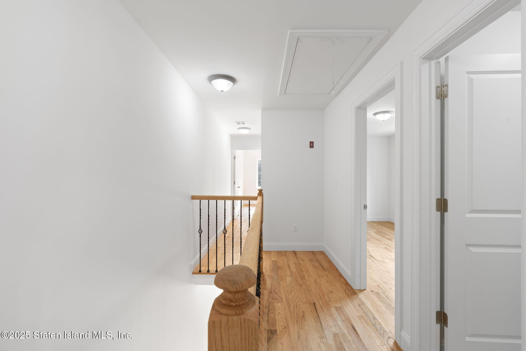 1372 Forest Hill Road, Unit 1A Staten Island, NY 10314 - Photo 11 of 25 a view of a hallway with wooden floor and staircase
