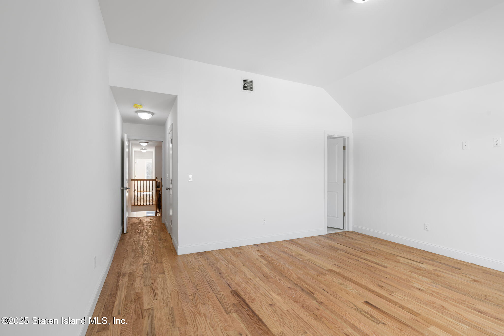 1372 Forest Hill Road, Unit 1A Staten Island, NY 10314 - Photo 14 of 25 a view of empty room with wooden floor