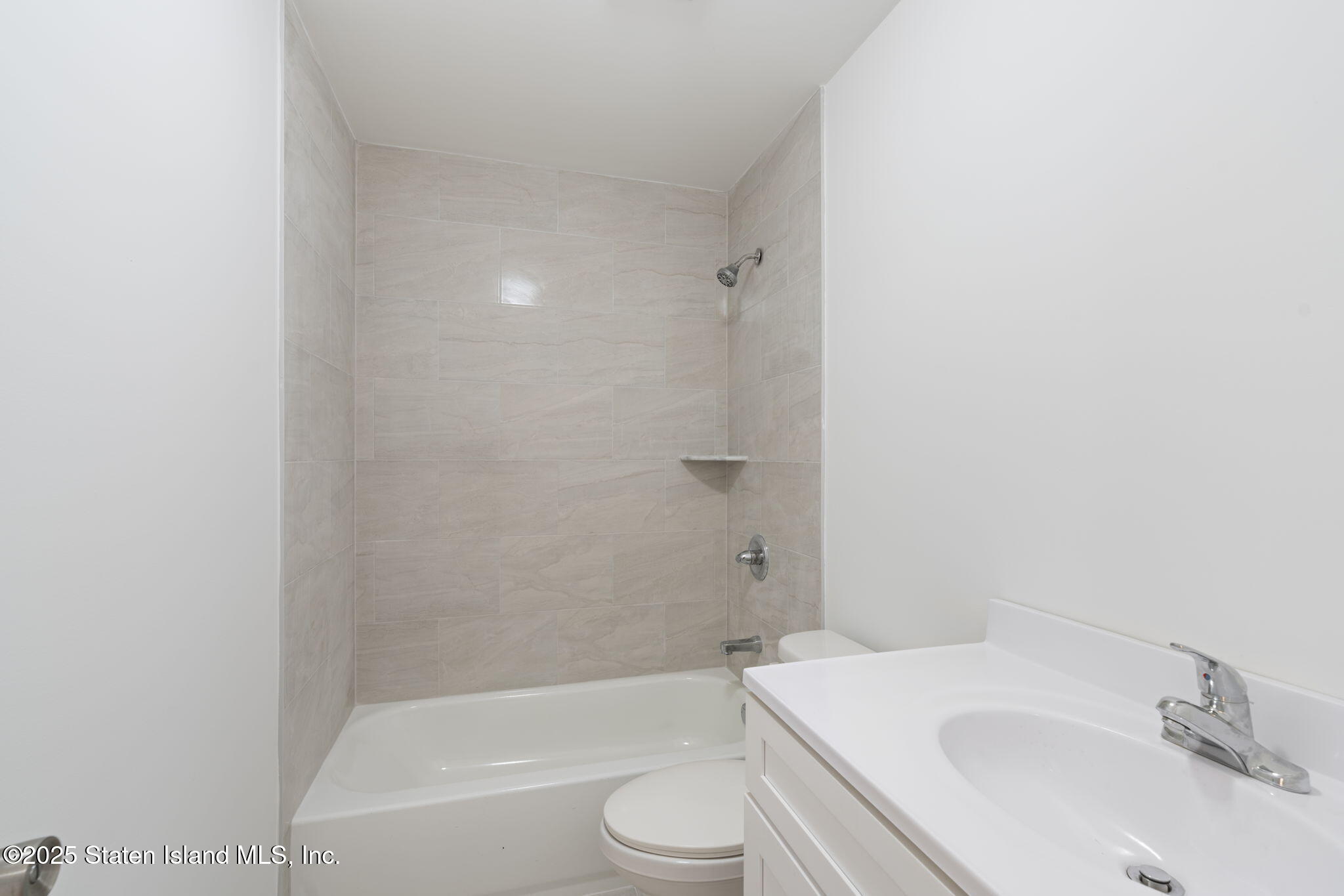 1372 Forest Hill Road, Unit 1A Staten Island, NY 10314 - Photo 19 of 25 a bathroom with a sink toilet and bathtub