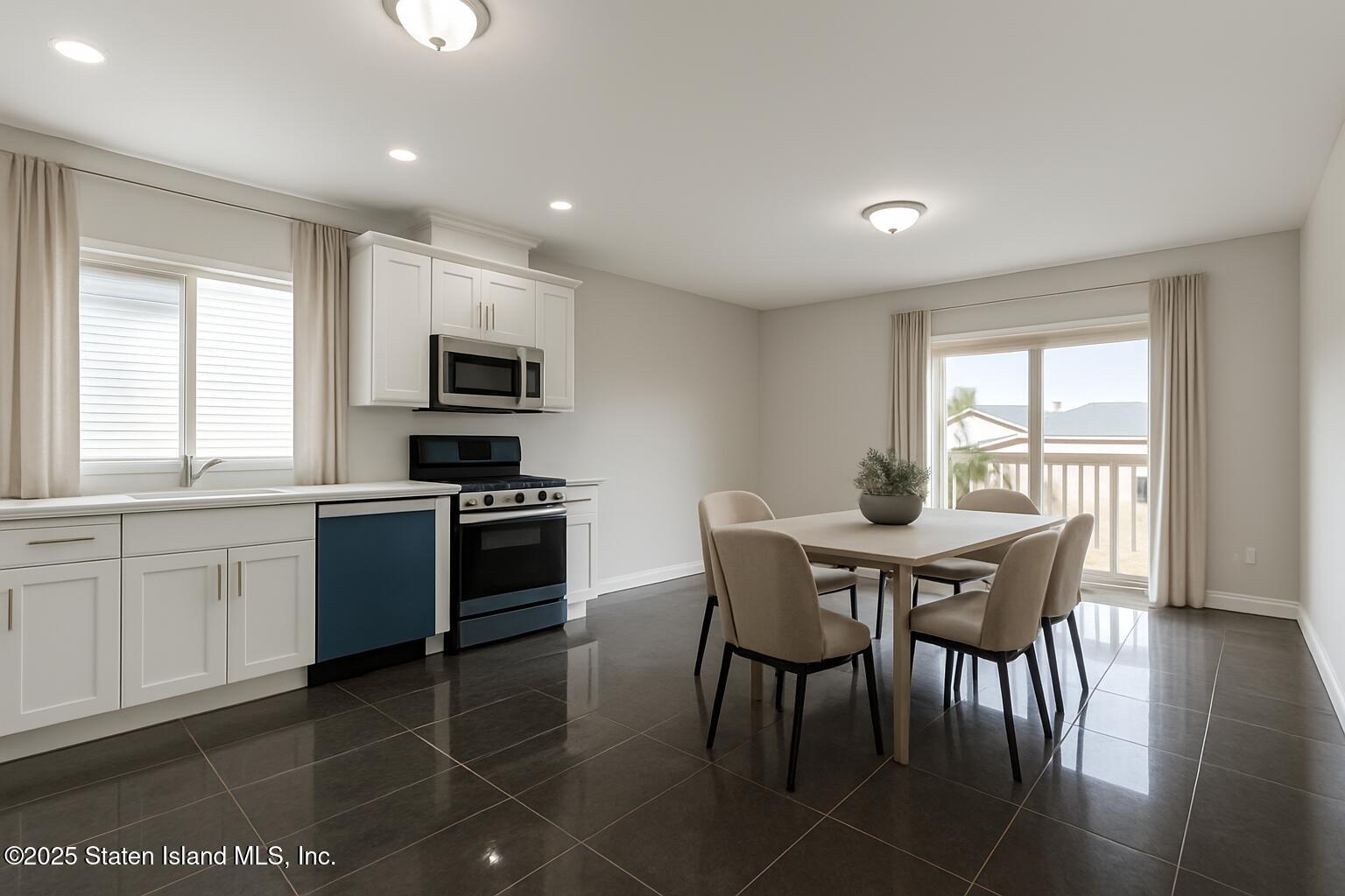 1372 Forest Hill Road, Unit 1A Staten Island, NY 10314 - Photo 4 of 25 a kitchen with stainless steel appliances granite countertop a stove a sink a microwave a dining table and chairs