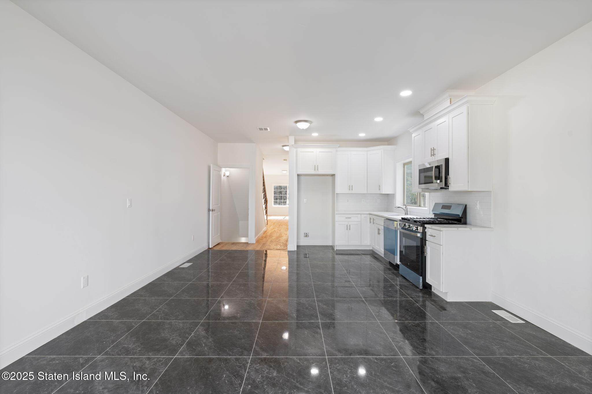 1372 Forest Hill Road, Unit 1A Staten Island, NY 10314 - Photo 10 of 25 a view of kitchen with kitchen island microwave and cabinets
