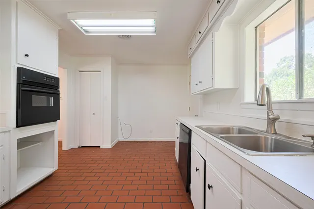a kitchen that has a sink and a stove in it