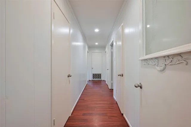 a view of a hallway with wooden floor