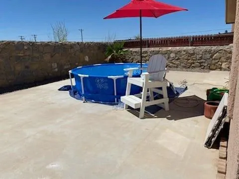 swimming pool view with a seating space