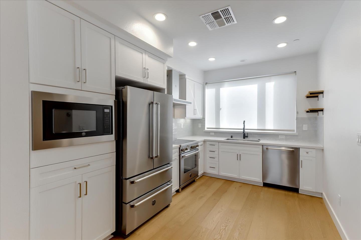 152 Uptown Circle Oakland, CA 94607 - Photo 13 of 33 a kitchen with stainless steel appliances a refrigerator sink and microwave