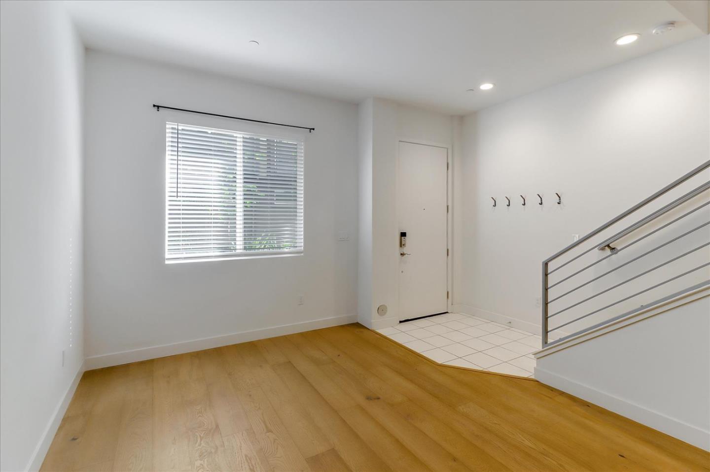 152 Uptown Circle Oakland, CA 94607 - Photo 4 of 33 a view of an empty room with wooden floor and a window