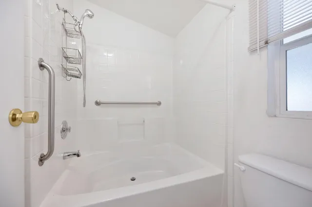 a bathroom with a glass shower door