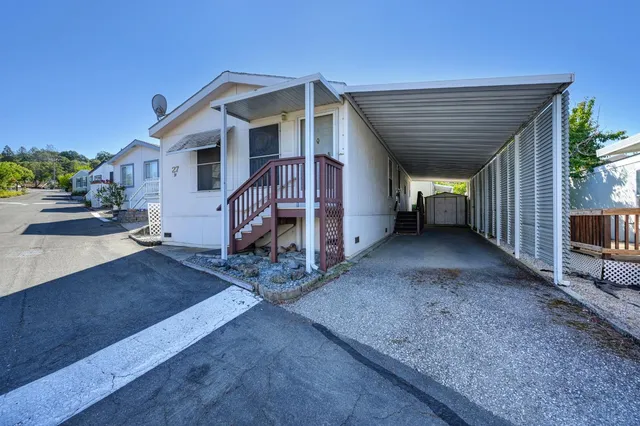 a view of a house with a backyard
