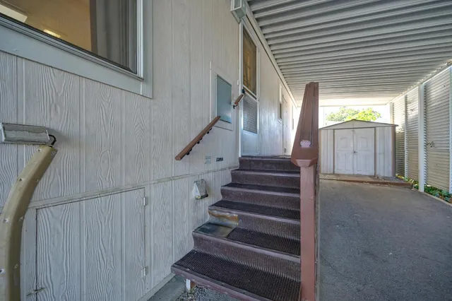 a view of a kitchen with a sink and a refrigerator
