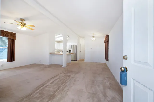 a view of an empty room with window and cabinet