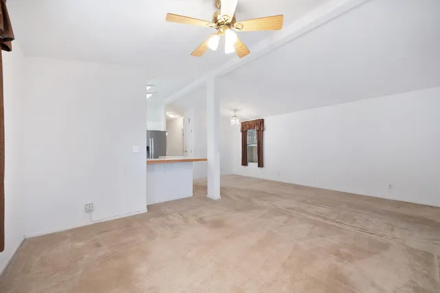 a kitchen with a sink dishwasher window and cabinets