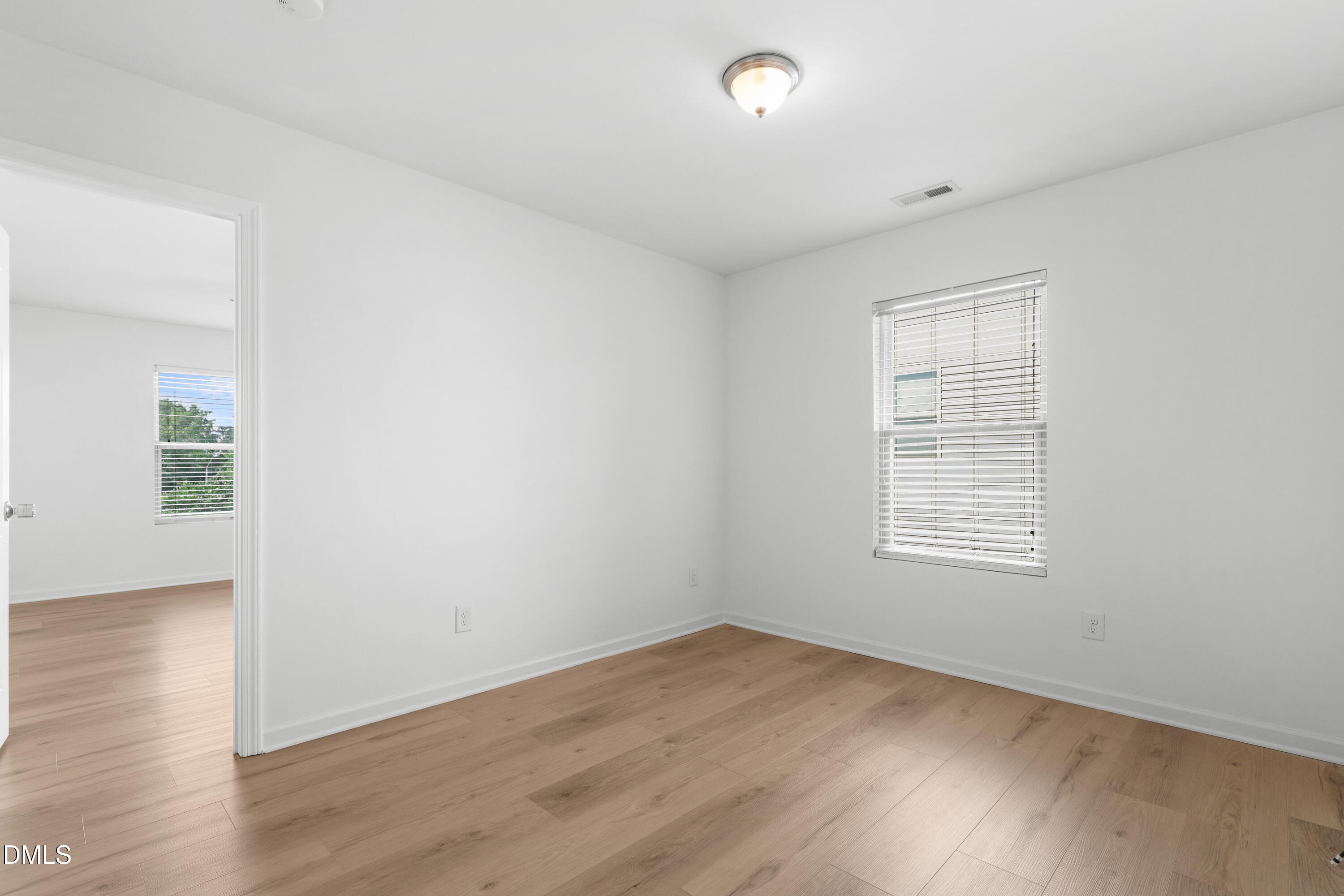 4400 Hillsgrove Road Wake Forest, NC 27587 - Photo 18 of 49 an empty room with wooden floor and windows