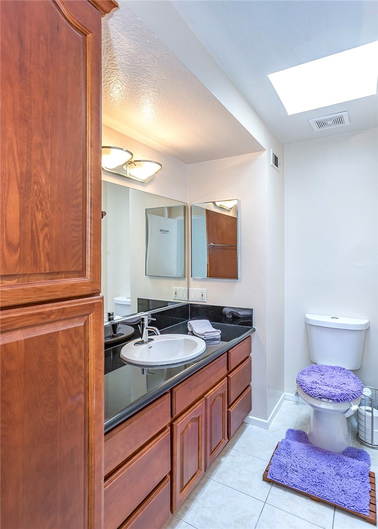 7065 9th Street, Unit 1 Buena Park, CA 90621 - Photo 17 of 36 a bathroom with a granite countertop sink and a mirror